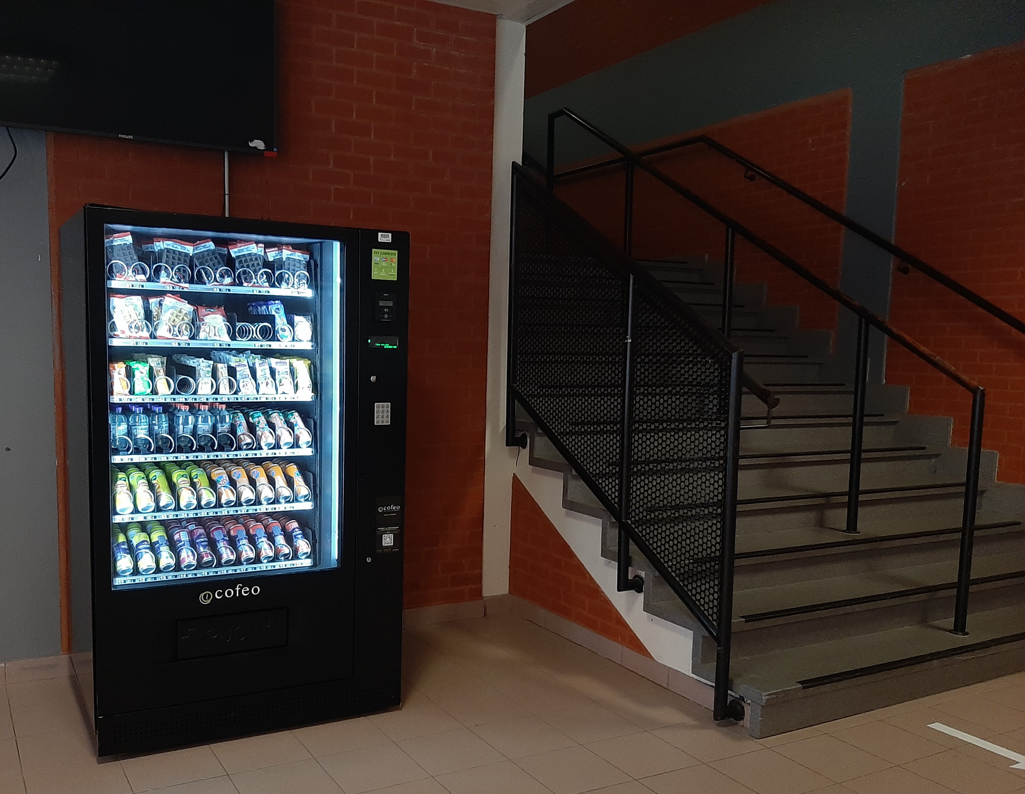 Vending machine next to the stairs leading from the Olympia area to the 1st floor of the Curie building 